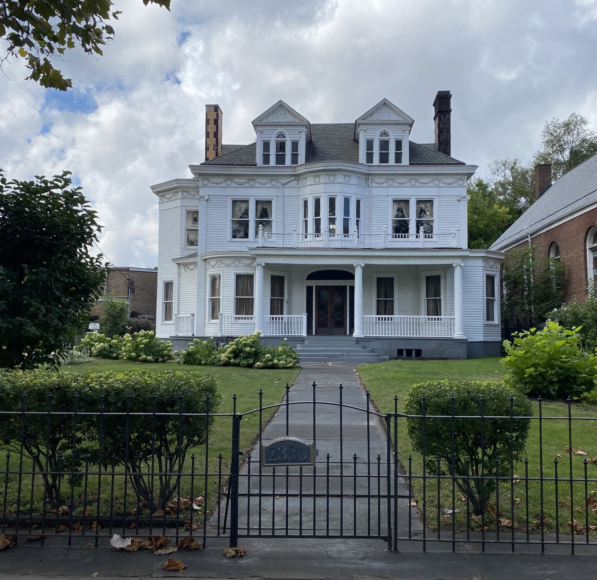 white mansion with gated entrance
